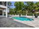 Private pool and spa surrounded by a stone patio and manicured landscaping for outdoor enjoyment at 9799 Covent Garden Dr, Orlando, FL 32827