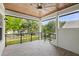 Covered porch featuring a wood ceiling, ceiling fan and views of the front yard and neighborhood at 9799 Covent Garden Dr, Orlando, FL 32827