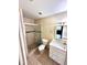 Tiled bathroom featuring glass-doored shower, toilet, and vanity with storage at 1001 Plantation Dr # E1, Kissimmee, FL 34741