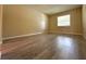 Bright bedroom with a large window, neutral walls, and modern laminate flooring for a clean, updated look at 1001 Plantation Dr # E1, Kissimmee, FL 34741
