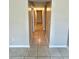 Hallway with ceramic tile flooring and neutral paint color at 1001 Plantation Dr # E1, Kissimmee, FL 34741