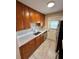 Efficient kitchen featuring stainless steel appliances, modern countertops, wooden cabinets and sink at 1001 Plantation Dr # E1, Kissimmee, FL 34741