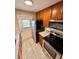 Efficient kitchen featuring stainless steel appliances, modern countertops and wooden cabinets at 1001 Plantation Dr # E1, Kissimmee, FL 34741