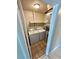 A compact laundry room area equipped with a washer, dryer, and shelving at 1001 Plantation Dr # E1, Kissimmee, FL 34741
