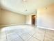Bright, open living room with ceramic tile flooring and neutral color paint at 1001 Plantation Dr # E1, Kissimmee, FL 34741