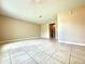 Bright, open living room with ceramic tile flooring and neutral color paint at 1001 Plantation Dr # E1, Kissimmee, FL 34741