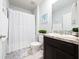 Clean bathroom featuring a shower with curtain, vanity sink, and neutral finishes at 1015 Andean Ln, Davenport, FL 33837