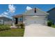 Charming single-story home with a two-car garage and well-maintained lawn at 1015 Andean Ln, Davenport, FL 33837