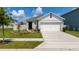 Well-maintained single-story home with a two-car garage, manicured lawn, and charming curb appeal at 1015 Andean Ln, Davenport, FL 33837