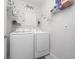 Laundry room featuring modern front load washer and dryer with decorative laundry themed wall art at 1015 Andean Ln, Davenport, FL 33837