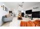 Open-concept living space with modern furniture, a ceiling fan, and seamless flow to the kitchen at 1015 Andean Ln, Davenport, FL 33837