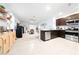 Open-concept kitchen and living space with modern appliances, stylish decor, and tile floors at 1015 Andean Ln, Davenport, FL 33837