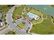 Aerial view showcasing the community pool, playground, common areas, and surrounding landscaping at 1015 Andean Ln, Davenport, FL 33837