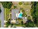 Private backyard retreat with a swimming pool, surrounded by lush greenery and a pergola-covered patio area at 1096 Dyson Dr, Winter Springs, FL 32708