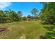 Spacious backyard with a fire pit, surrounded by lush greenery and mature trees at 1096 Dyson Dr, Winter Springs, FL 32708