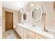 Bathroom featuring double vanity, overhead lighting, and decorative mirrors at 1096 Dyson Dr, Winter Springs, FL 32708