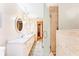 Bathroom with double vanity, decorative mirrors, and a separate glass door shower at 1096 Dyson Dr, Winter Springs, FL 32708