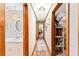 Hallway with access to the bathroom and bedrooms; features wood look tile flooring, wood trim, and neutral paint at 1096 Dyson Dr, Winter Springs, FL 32708