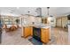 Open concept kitchen featuring wood look tile flooring, wood cabinets, granite countertops, and stainless steel appliances at 1096 Dyson Dr, Winter Springs, FL 32708