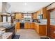 Well-lit kitchen featuring granite countertops and wood cabinetry at 1096 Dyson Dr, Winter Springs, FL 32708