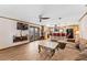Open concept living room area featuring wood look tile flooring, wood trim, comfortable seating, and french doors at 1096 Dyson Dr, Winter Springs, FL 32708