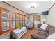 Cozy living room features wood look tile flooring, wood trim, comfortable seating, and shuttered windows at 1096 Dyson Dr, Winter Springs, FL 32708