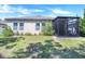 Well-maintained backyard with lush green grass, landscaping, and a screened lanai, perfect for outdoor activities at 1096 Roberta Rd, Lake Wales, FL 33853