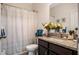 Well-lit bathroom with a granite countertop vanity, a shower-tub combo, and neutral decor at 1096 Roberta Rd, Lake Wales, FL 33853