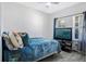 Cozy bedroom featuring a comfortable bed, stylish decor, and natural light from the window at 1096 Roberta Rd, Lake Wales, FL 33853