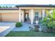 Inviting front porch with rocking chairs, decorative plants, and a well-maintained lawn at 1096 Roberta Rd, Lake Wales, FL 33853