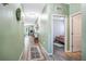 Hallway with modern lighting, wood-look floors, and neutral walls leading to the bedroom at 1096 Roberta Rd, Lake Wales, FL 33853