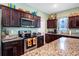 Modern kitchen with stainless steel appliances, dark wood cabinets, and granite countertops at 1096 Roberta Rd, Lake Wales, FL 33853