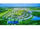Community aerial view showcasing lush landscapes, shimmering lakes, and peaceful surroundings at 12715 Moss Park Ridge Dr, Orlando, FL 32832