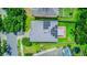 Aerial view of the home with solar panels, brick patio, and green landscaping at 12715 Moss Park Ridge Dr, Orlando, FL 32832
