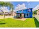 Spacious backyard with well-maintained lawn, screened-in patio, and privacy fencing at 12715 Moss Park Ridge Dr, Orlando, FL 32832