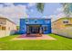 Large backyard with a screened-in patio and lush green grass, perfect for outdoor activities at 12715 Moss Park Ridge Dr, Orlando, FL 32832