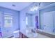 This bathroom features a new vanity and a mirror, plus a toilet and shower at 12715 Moss Park Ridge Dr, Orlando, FL 32832