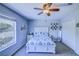 This bedroom features a bed and bedside tables, plus a large window for natural light at 12715 Moss Park Ridge Dr, Orlando, FL 32832