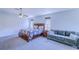 This bedroom provides a cozy sofa, bedside tables, and natural light, perfect for a relaxing night's sleep at 12715 Moss Park Ridge Dr, Orlando, FL 32832