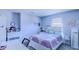The bedroom is decorated with charming butterfly decals, a comfortable bed, and plenty of natural light at 12715 Moss Park Ridge Dr, Orlando, FL 32832