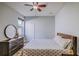 Comfortable bedroom with a ceiling fan, dresser, and plenty of natural light at 12715 Moss Park Ridge Dr, Orlando, FL 32832