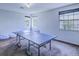 This bonus room features a ping pong table, perfect for the whole Gathering to enjoy at 12715 Moss Park Ridge Dr, Orlando, FL 32832