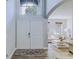 Bright entryway with hardwood floors, double doors, and a view into the welcoming living room at 12715 Moss Park Ridge Dr, Orlando, FL 32832