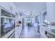Modern kitchen featuring white cabinets, stainless steel appliances, and a cozy breakfast nook at 12715 Moss Park Ridge Dr, Orlando, FL 32832
