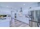Bright kitchen with white cabinetry, stainless steel appliances, and modern countertops at 12715 Moss Park Ridge Dr, Orlando, FL 32832