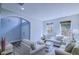 Bright living room featuring lots of seating, windows, throw pillows, and wood floors at 12715 Moss Park Ridge Dr, Orlando, FL 32832