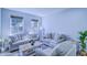 Cozy living room with neutral sofas, accent pillows, and natural light at 12715 Moss Park Ridge Dr, Orlando, FL 32832
