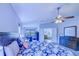 A serene main bedroom is bright with natural light, and includes a desk area and private ensuite at 12715 Moss Park Ridge Dr, Orlando, FL 32832
