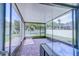 Relaxing screened-in patio featuring brick flooring and views of the manicured backyard at 12715 Moss Park Ridge Dr, Orlando, FL 32832