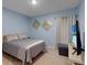 Well-lit bedroom with neutral walls, comfortable bed, and stylish decor for a relaxing atmosphere at 1278 Asher Mason Ave, Kissimmee, FL 34744